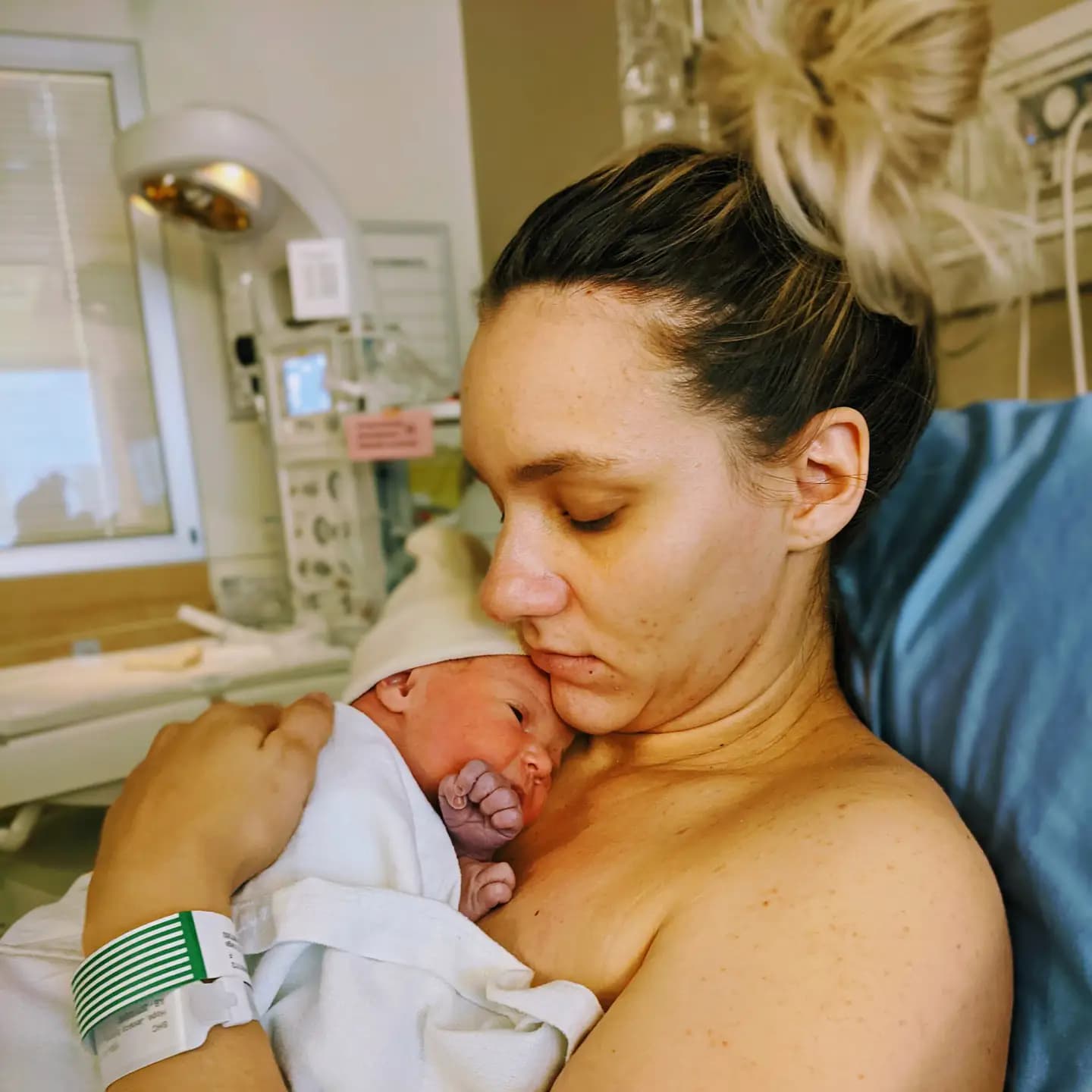 Newborn baby with purple hands and mother