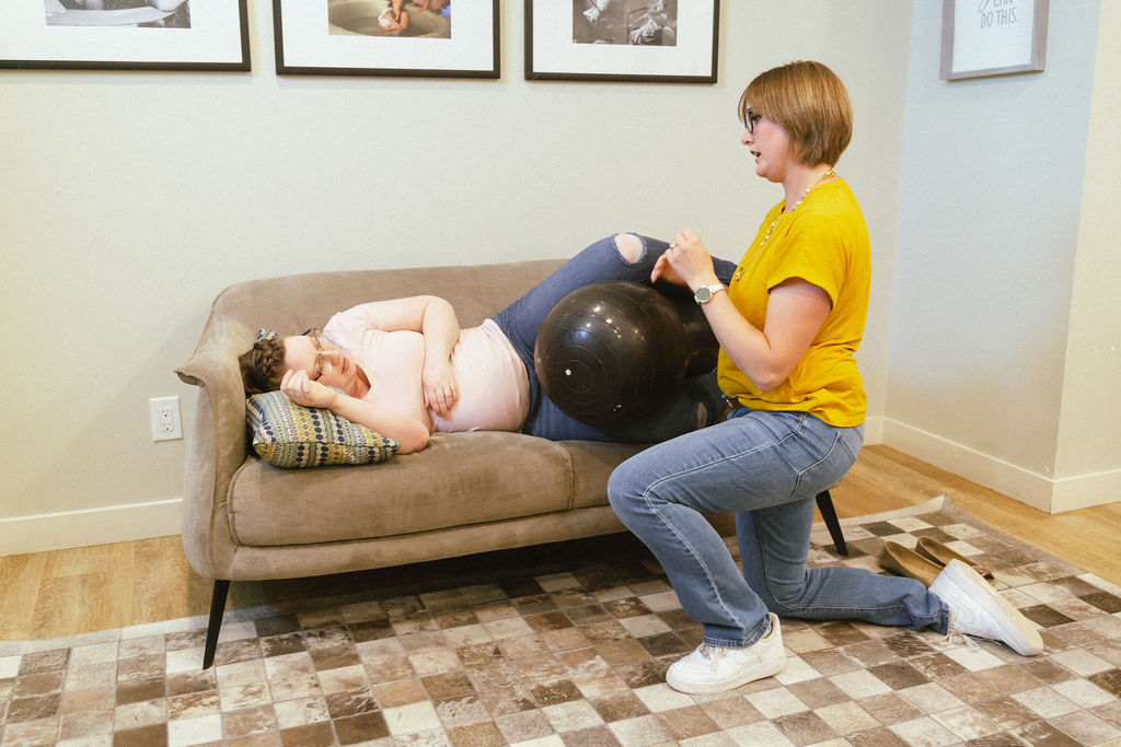 Prenatal instructor teaching how to use a peanut ball