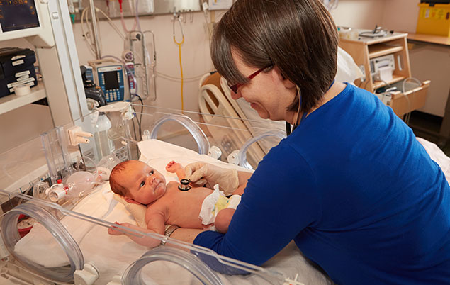 midwife checking newborn in hospital