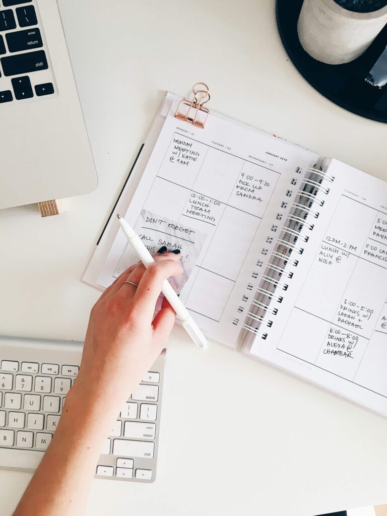 Woman writing in planner