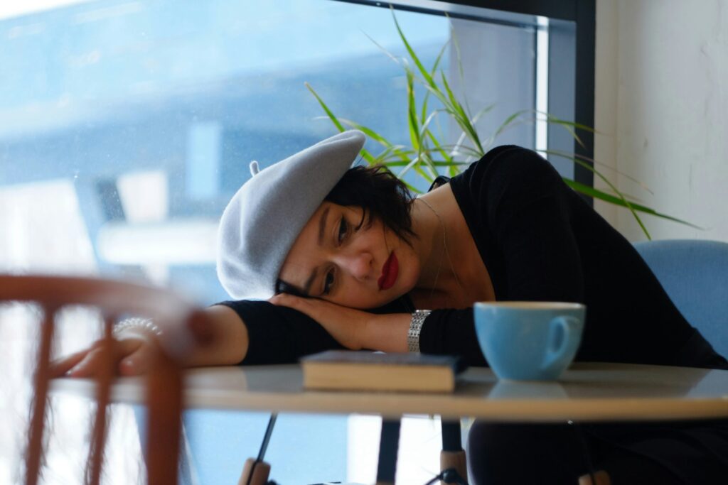 Woman tiredly leaning on table