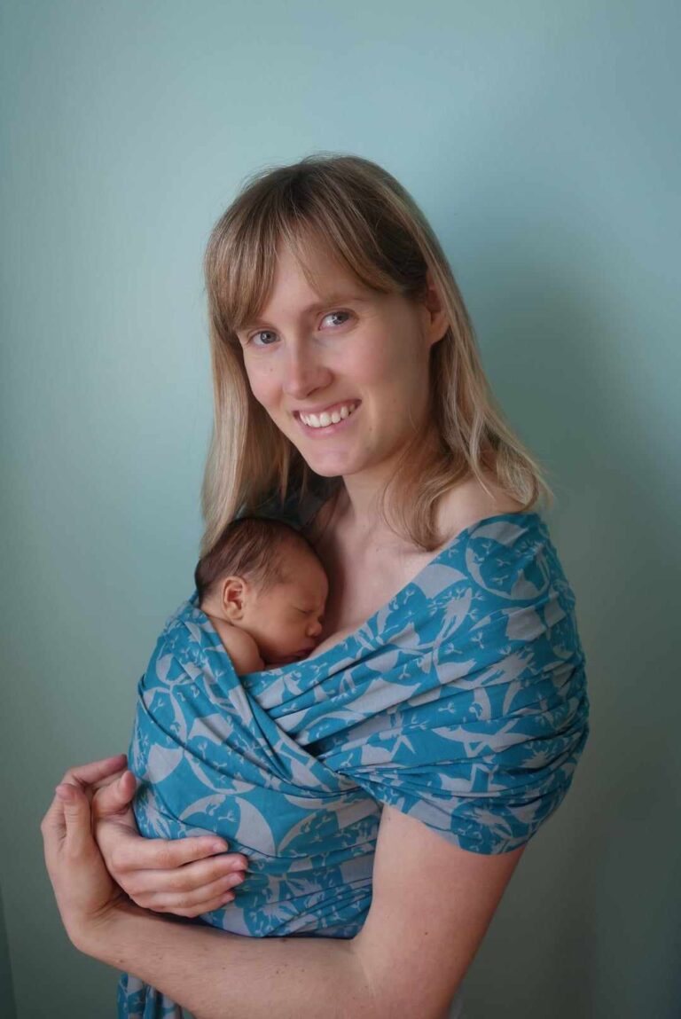 Mother babywearing newborn